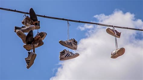 shoes hanging from power lines meaning.